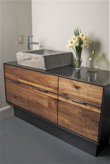 carved stone sink on steel vanity